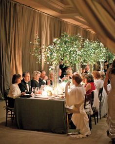 a group of people sitting around a dinner table