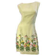 Chic 1960s pale yellow embroidered linen sheath dress ! Features intricate embroidery of flowers and daisies throughout the front and back hem. Fully lined. Hidden metal zipper up the back with hook-and-eye closure. Perfect for any spring /summer day or evening event. Pair with wedges, sandals, flats for day, or heels for evening. Very well made, with heavy attention to details. In great condition Approximately Size Medium Measurements: 38 inch bust 28-29 inch waist 38 inch hips 37.5 inches from 1920s Evening Gowns, 1950s Cocktail Dress, Silk Velvet Dress, Linen Sheath Dress, Informal Dress, Empire Maxi Dress, Black Lace Cocktail Dress, 70s Maxi Dress, Sandals Flats