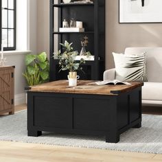 a living room with a coffee table and bookshelf