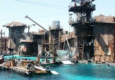 an industrial area with large metal structures in the water