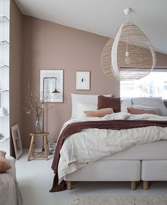 a bed sitting in a bedroom on top of a white floor next to a window