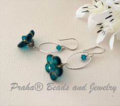 Great earrings for spring and summer...teal Czech glass flower beads are accented with gold trim. Teal beads measure 15MM, with a depth of 6MM. Earrings have Swarovski crystal accents and bright sterling silver oval components. Elegant Turquoise Flower Earrings Nickel Free, Elegant Turquoise Nickel-free Flower Earrings, Lampwork Jewelry