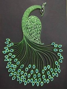 an intricately designed peacock is displayed on a black surface with blue and green feathers