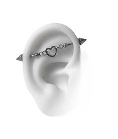 an ear with two spikes and a heart on the middle one is made out of white ceramic