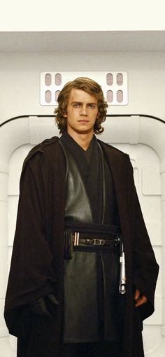 a young man dressed in darth vader costume