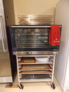 an oven sitting next to a refrigerator in a kitchen