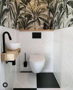 a white toilet sitting in a bathroom next to a black and white checkered floor