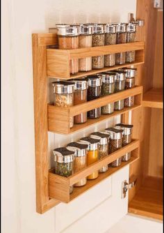 an organized spice rack in the corner of a kitchen