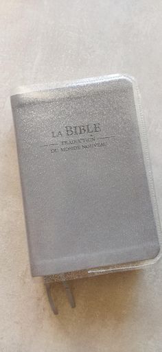 a silver book sitting on top of a white table