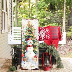 a snowman is on the porch next to a christmas tree