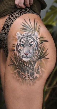 a woman with a tiger tattoo on her thigh