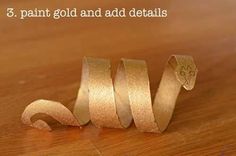 three rolls of gold colored ribbon sitting on top of a wooden table with the words 3 paint gold and add details