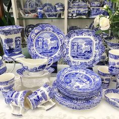 a table topped with blue and white china