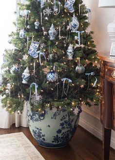 a decorated christmas tree in a blue and white pot