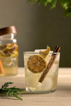 two glasses filled with lemonade and cinnamon sticks