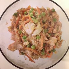 a glass bowl filled with rice and vegetables