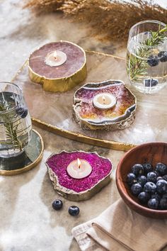 candles and blueberries are sitting on a table