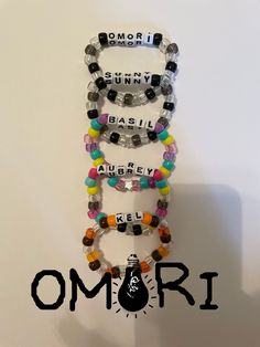 Bracelets I made based off of Omori characters! They are colorful, well made, and stretchy so they fit everyone!  Every bracelet has 27-28 beads including the letters. Sbg Webtoon Bracelet, Keroppi Bracelet, Omori Kandi, Scene Kandi Bracelets, Miku Kandi, Character Kandi, Matching Kandi Bracelets, Kandi Singles Ideas, Bracelet Ideas Beads