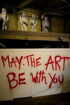 graffiti on the side of a building that says, may the art be with you