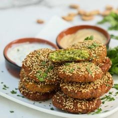 some food that is on a plate with dipping sauces in the bowl next to it