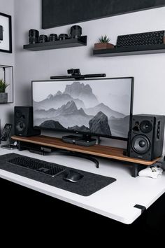 there is a computer on the desk with speakers