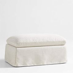 a white ottoman sitting on top of a floor