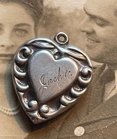 This is a sterling silver puffy heart from the 1940’s engraved with the name Jackie.Collect your friends and family names and monograms to create a really unique piece of jewelry that will become an heirloom passed down for generations. Remember to keep notes concerning the persons represented by the love token, puffy heart of charm. This is called the provenance of the piece and it increases the value of the item. More than a financial value, these types of heirlooms mean so much to those famil Classic Double Heart Engraved Jewelry, Classic Engraved Double Heart Jewelry, Vintage Engraved Heart Cut Jewelry, Classic Heart-shaped Collectible Jewelry, Classic Heart Jewelry For Collectibles, Classic Heart Shaped Collectible Jewelry, Collectible Heart-shaped Hallmarked Jewelry, Vintage Double Heart Personalized Jewelry, Personalized Vintage Double Heart Jewelry