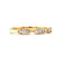 a yellow gold ring with three diamonds on the inside and outside, set against a white background