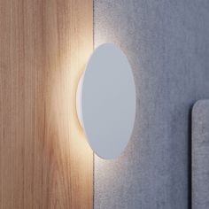 a white light on the side of a wooden wall