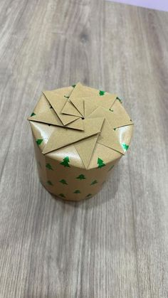 an origami box sitting on top of a wooden table