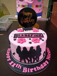 a birthday cake with pink and black frosting