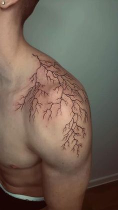 a man's chest is shown with branches on it