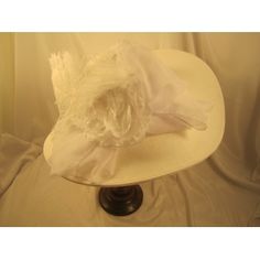 Large White Kentucky Derby Hat. Beautiful new Kentucky Derby hat.White Large Brim Derby Hat with White. This is from our new Kentucky Derby hat collection. This hat has a x-large white 7" brim, white chiffon band around the crown, white chiffon bow, big white flower, white feathers. Fitted Flat Brim Top Hat For Spring, Spring Fitted Flat Brim Top Hat, Classic Fitted Fascinator With Wide Brim, Classic Wide Brim Fitted Fascinator, Classic White Fitted Top Hat, Fitted White Top Hat For Church, White Fitted Top Hat For Church, Classic Mini Hats For Spring Wedding, Classic Fitted Hat For Races