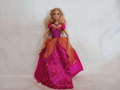 a barbie doll wearing a purple dress and pink shoes on a white background with a red cape