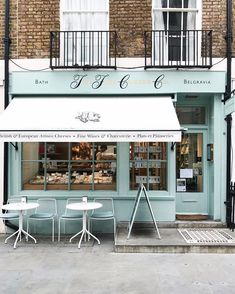 the outside of a bakery with tables and chairs