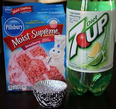 a bottle of soda next to a cupcake tin and a bag of frosting