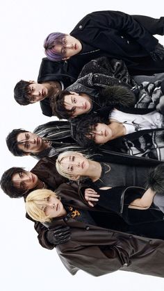 a group of young people standing next to each other in front of a white background