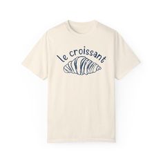 "Le Croissant" Graphic Tee - Serve up Parisian vibes with a side of chic in this cute, French café-inspired essential! We use professional quality DGT printing on all our apparel. Direct-to-garment, or DTG, is a high quality printing method that sprays ink directly onto the garment so there is no peeling or cracking. This fabulous graphic will be printed on a Comfort Colors Unisex T-Shirt. Please refer to the size charts in the images for the best fit.  Estimated Production Time: 1-5 days Estimated Shipping Time: 2-5 days 100% cotton shirt  Machine wash: cold  Non-chlorine: bleach as needed Tumble dry: low heat Iron, steam or dry: medium heat Do not dry clean Casual Screen Print T-shirt For Brunch, Cotton T-shirt With Letter Print For Brunch, Short Sleeve T-shirt With Screen Print For Brunch, Short Sleeve Screen Print T-shirt For Brunch, Graphic Tee With Letter Print For Brunch, Short Sleeve Screen Print Tops For Brunch, Cotton Graphic Print T-shirt For Brunch, Graphic Tee For Brunch With Short Sleeves, Graphic Tee With Screen Print For Brunch