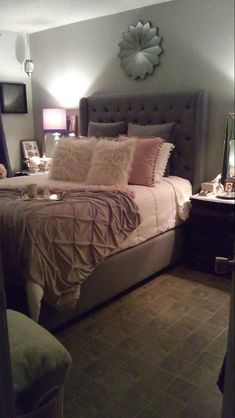 a bedroom with a large bed and two lamps on either side of the headboard