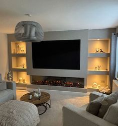 a living room filled with furniture and a flat screen tv mounted on the wall over a fire place