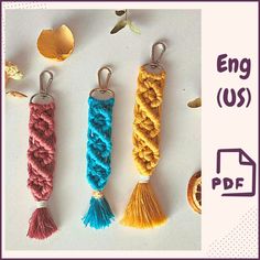 three different colored tassels are shown with the words eng us on it and an orange, yellow, blue, and pink tassel