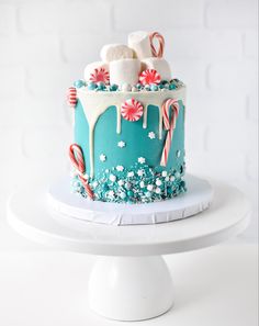 a cake decorated with candy canes and marshmallows