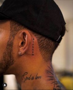 a man with a tattoo on his neck has the words god is love behind him