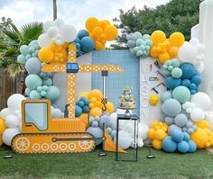 a construction themed birthday party with balloons and streamers in the shape of a bulldozer