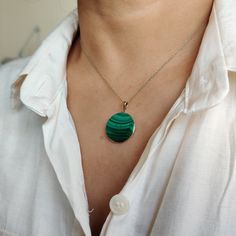 ITEM DESCRIPTION: >>The pendant is made from Solid 14K Yellow Gold. Gemstone used is absolutely natural and ethically sourced. >>Natural Flat cut Malachite in round shape with bezel setting are studded on it with utmost precision. >>This is a minimalist design and is absolutely hassle-free and everyday jewelry. ✓ Gem: Malachite ✓ Gem size: 20x20 mm round ✓ Gem weight: 17.65 carats ✓ Gold purity: 14K (58.33% approx.) ✓ Gold weight: 0.65 grams ✓ Gross weight: 4.18 grams The Gold purity is guarante Oval Malachite Jewelry In Yellow Gold, Yellow Gold Malachite Pendant Jewelry, Malachite Round Gemstone Jewelry, Fine Jewelry Malachite Round Jewelry, Round Malachite Gemstone Jewelry, Fine Jewelry With Round Malachite, Round Malachite Fine Jewelry, Green 14k Gold Necklace With Polished Finish, 14k Gold Green Necklace With Polished Finish