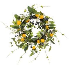 a wreath with oranges and blackberries on it is displayed against a white background