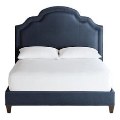 a blue bed with white sheets and pillows on top of the headboard is shown