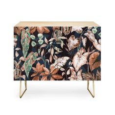 the sideboard is decorated with flowers and leaves on black, green, pink and gold