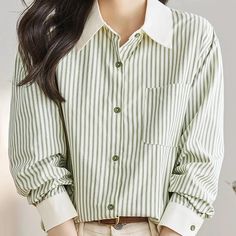 Infuse your wardrobe with a touch of elegance and sophistication with our Chic Green Striped Chiffon Blouse. Perfect for the modern woman who cherishes both style and comfort, this blouse boasts a flowing, loose fit and a classic striped pattern that never goes out of style. Whether you're heading to the office or dressing up for a casual outing, this top ensures you look effortlessly chic in any setting. Product Features Fabric: Luxurious chiffon that offers breathability and a gentle, silky touch against your skin. Design: Trendy green stripes on a crisp white background, paired with a smart turn-down collar and full-length sleeves. Fit: Designed for a loose fit, ensuring freedom of movement and all-day comfort. Details: Features a single-breasted button-up front for easy wear and adjust Striped Chiffon Blouse, Chic Blouses, Blouse For Women, Loose Fitting Tops, Chiffon Blouse, Look Chic, Green Stripes, Out Of Style, Easy Wear