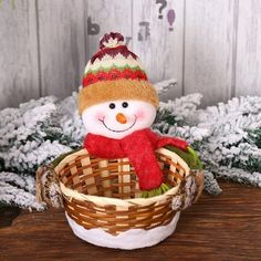 a small snowman sitting in a basket